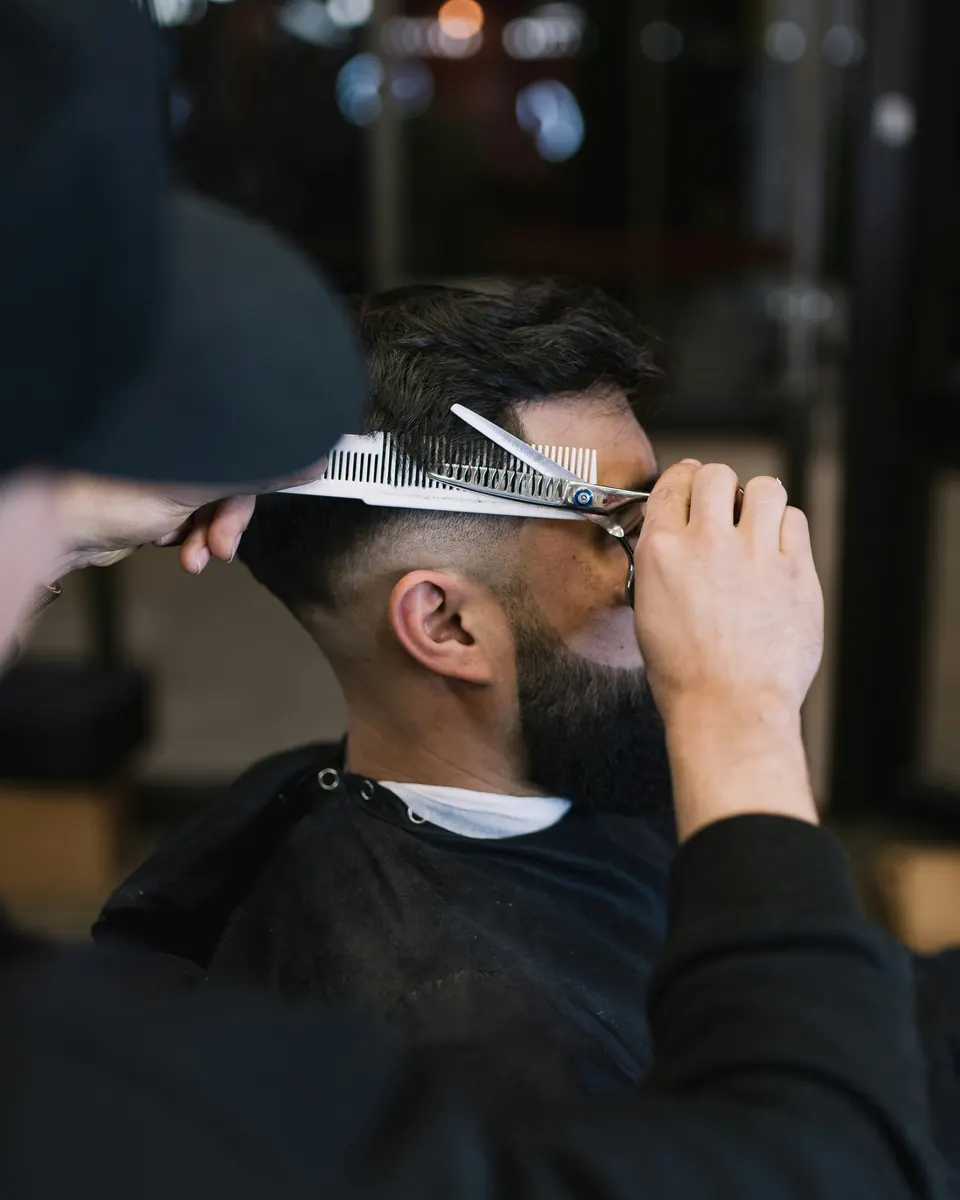 Professional barber preparing a barber invoice template for customer services