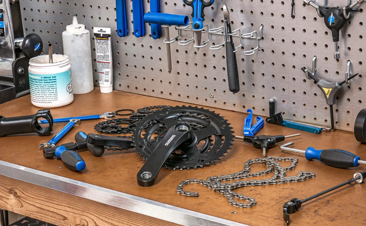 Bike shop mechanic servicing a bicycle and recording parts and labour