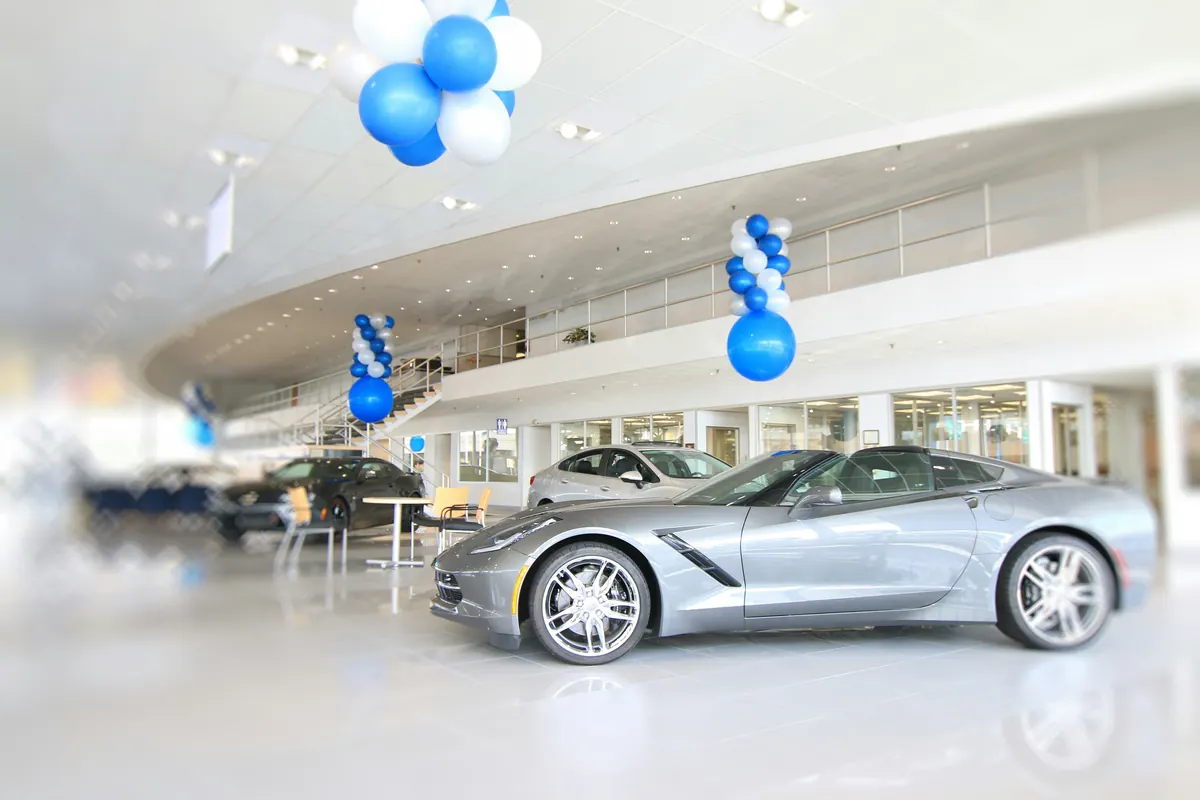 Vehicle buyer reviewing a car dealer invoice and purchase receipt