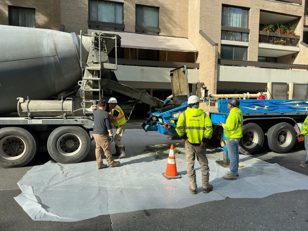 Concrete pump operator completing pumping work at a construction site