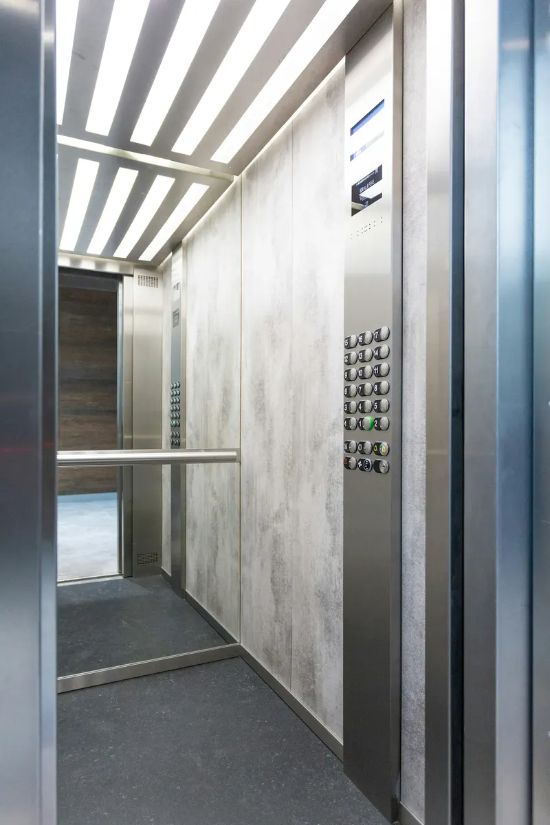 Elevator service contractor calculating lift repair and maintenance costs