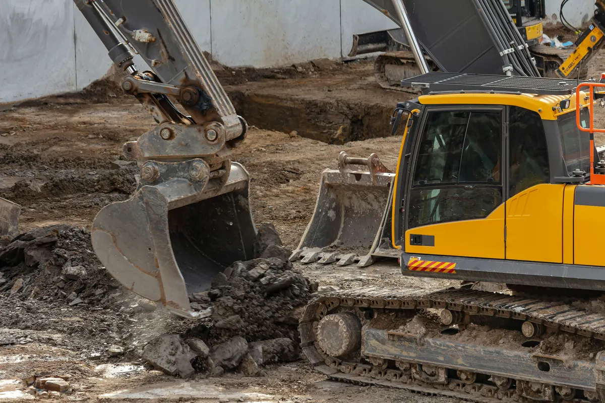 Excavation contractor operating an excavator on a construction site