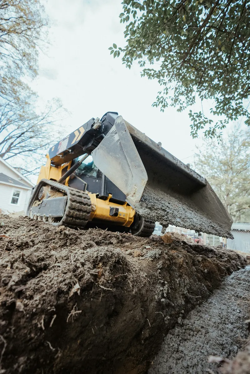 Excavator completing digging and earthmoving work at a job site