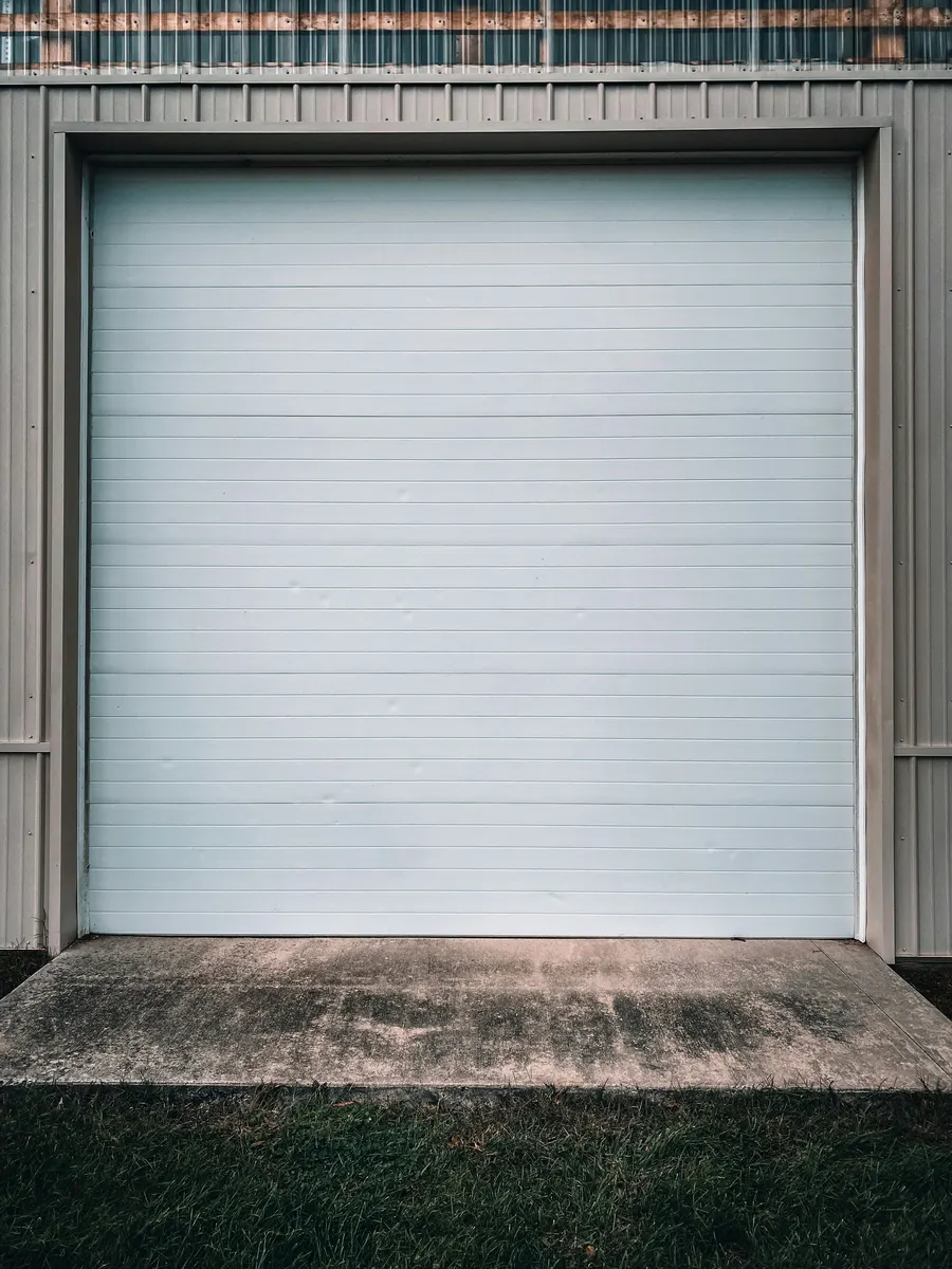 Garage door repair technician working on a residential garage door