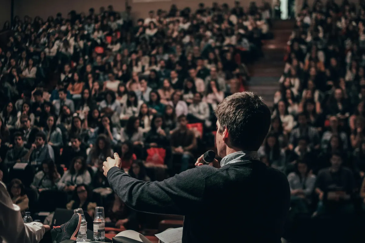 Professional guest speaker preparing an invoice template after a conference presentation