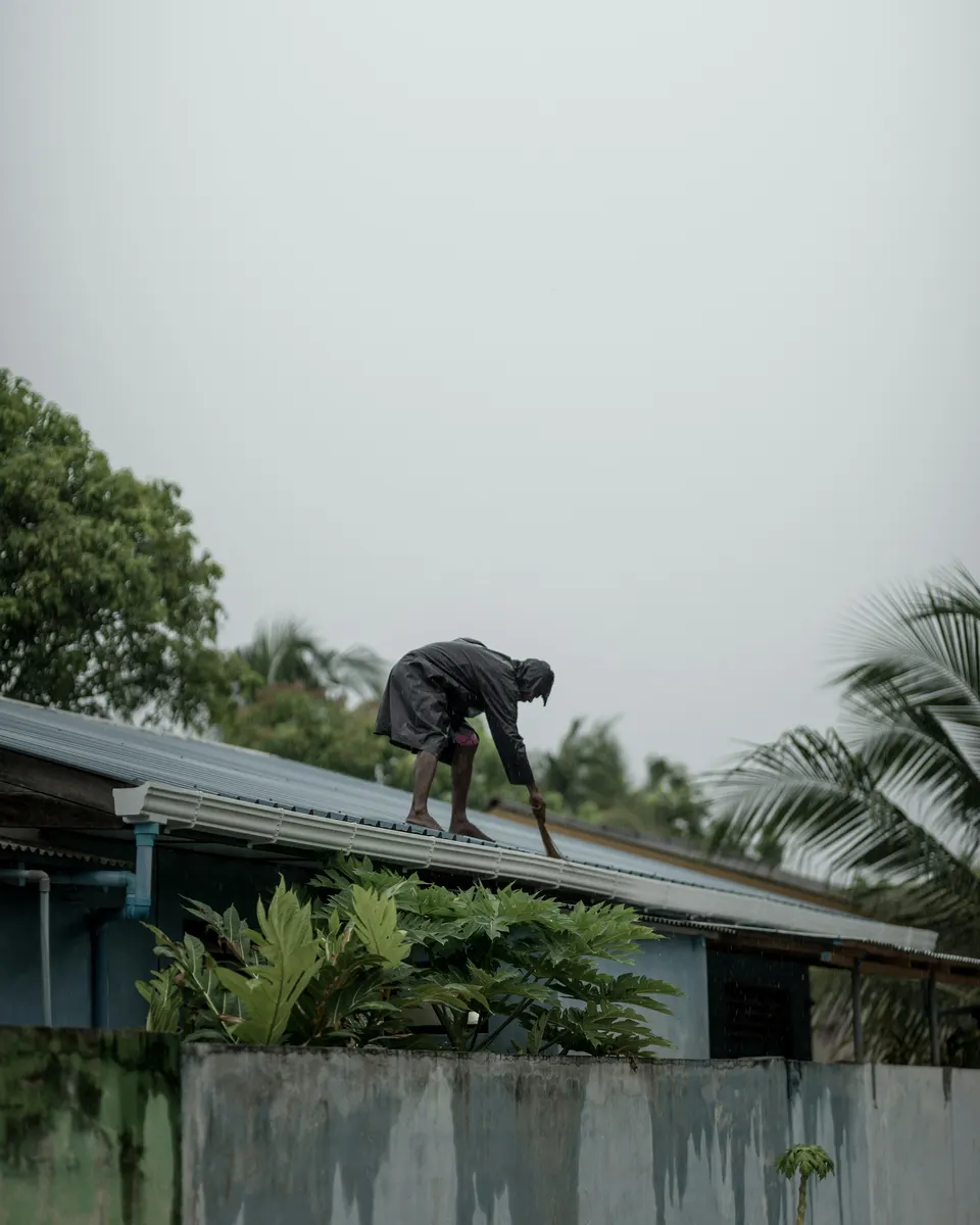 Gutter cleaner preparing a gutter cleaning invoice after completing work