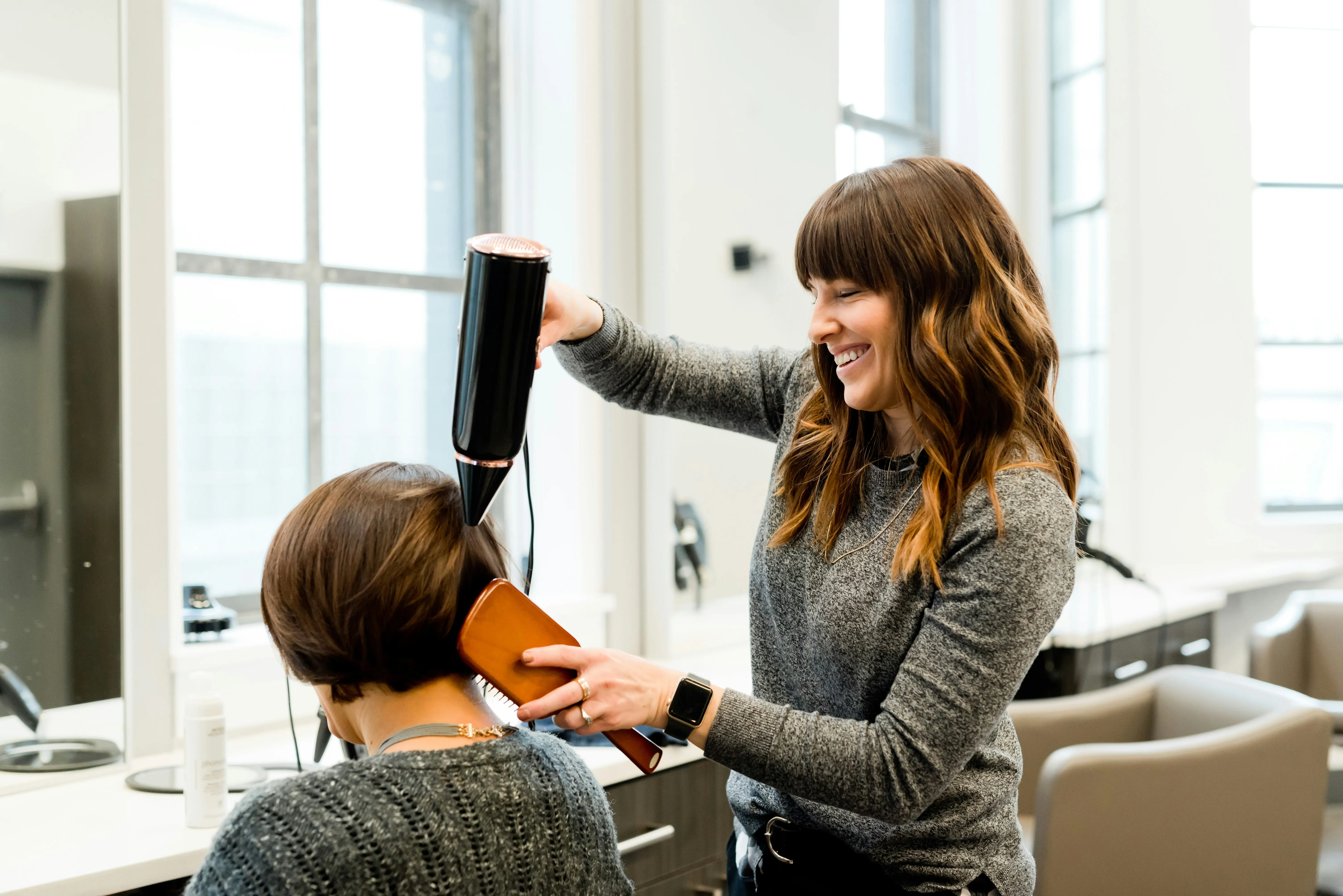 Hair stylist preparing a professional hair salon invoice for salon services