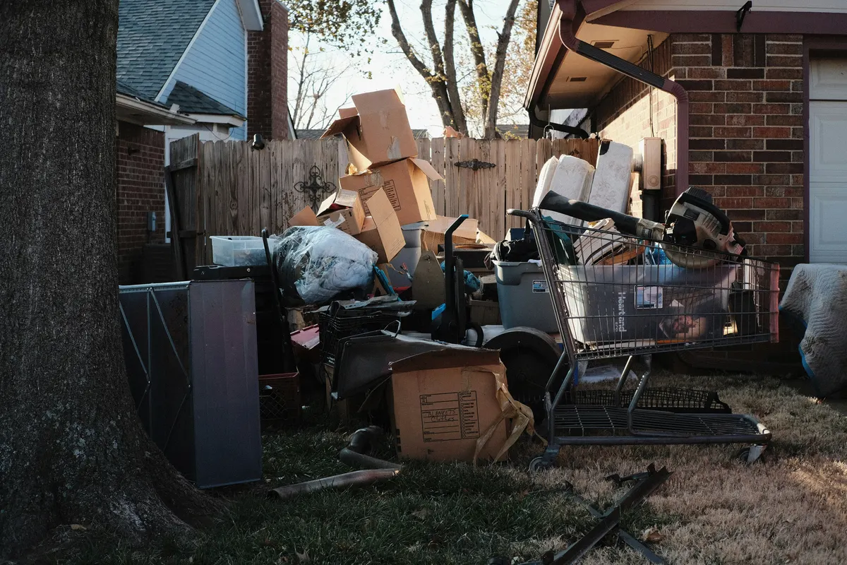 Waste removal workers collecting rubbish for a customer clearance job