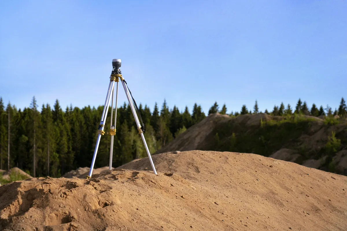 Surveyor reviewing property measurements and preparing a surveying invoice