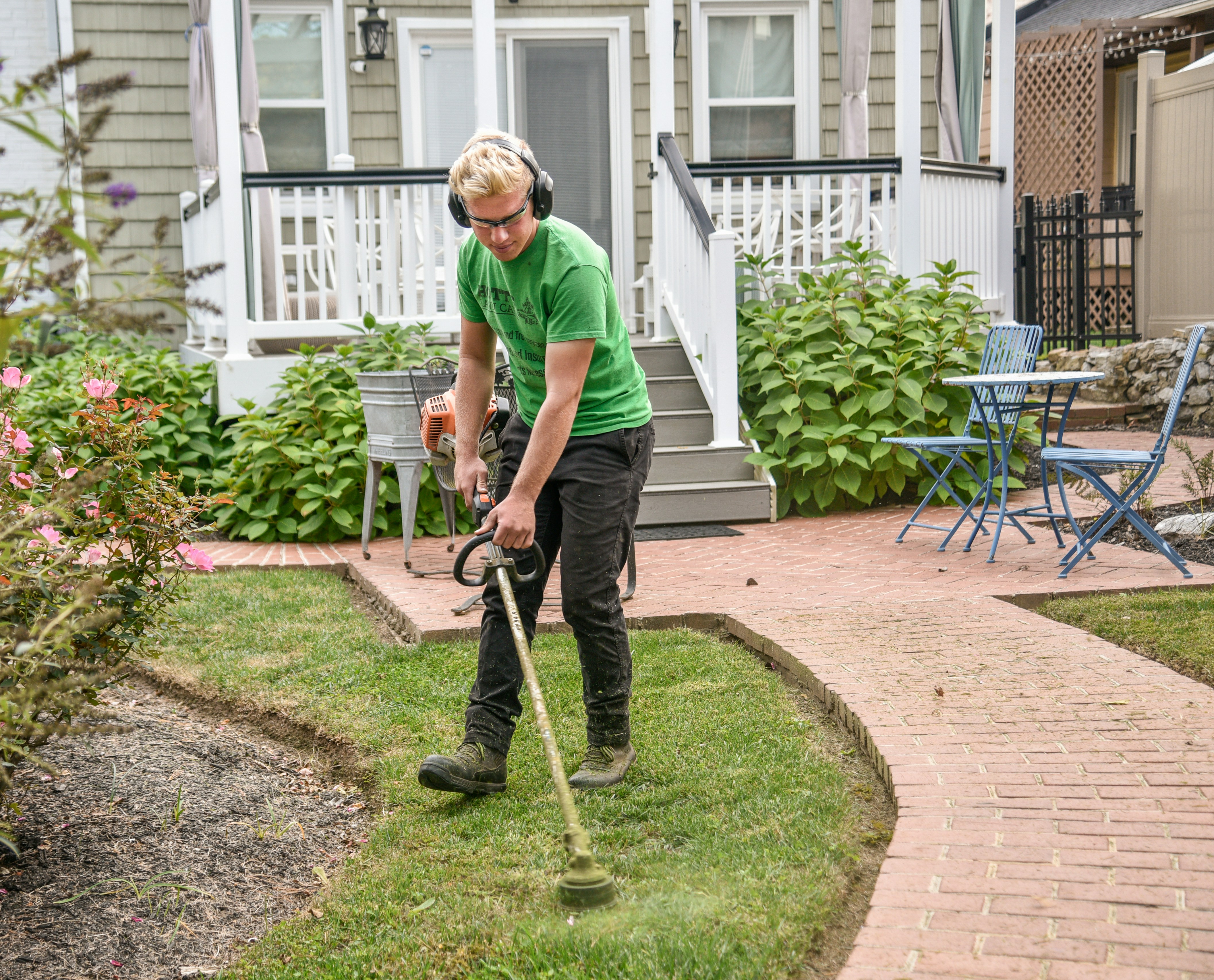 Landscaper preparing an invoice for lawn care and landscaping services