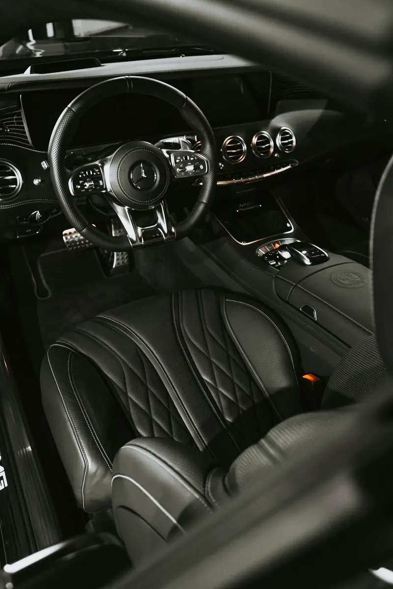 Auto detailer cleaning and detailing a customer's vehicle