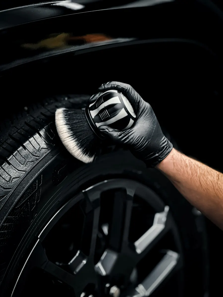 Car detailing professional completing customer billing after detailing a vehicle