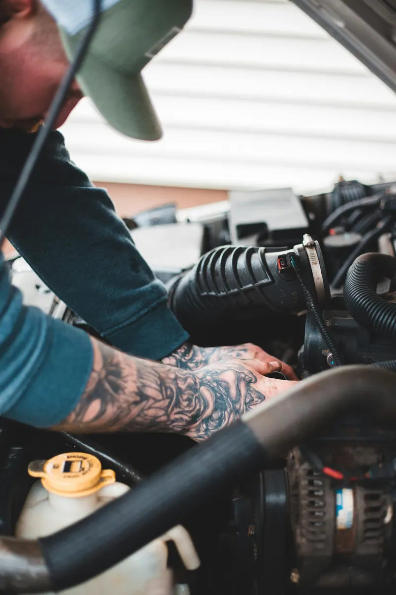 Mobile mechanic preparing an invoice after completing a vehicle repair
