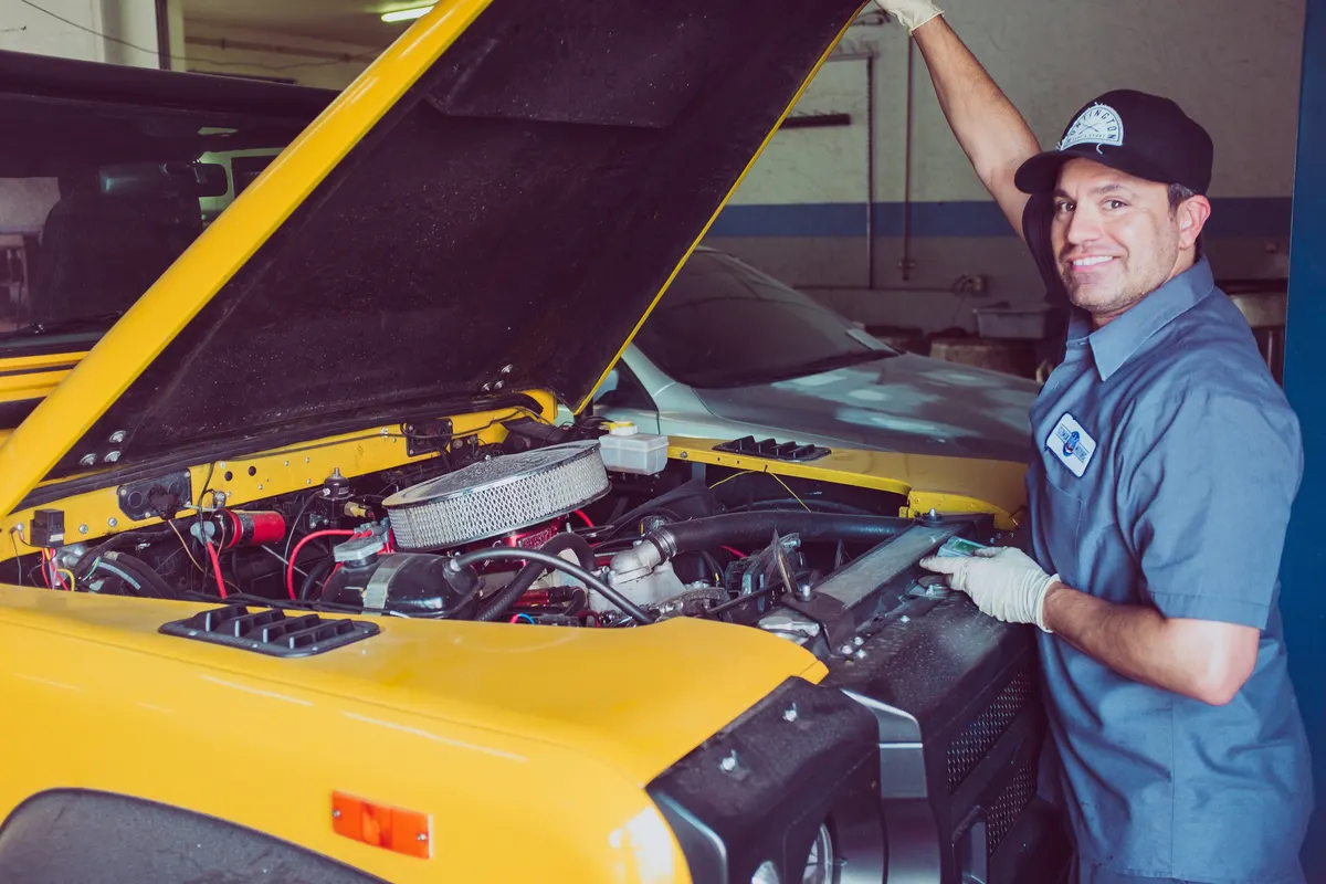 Mechanic completing a mobile mechanic invoice and receipt for a customer