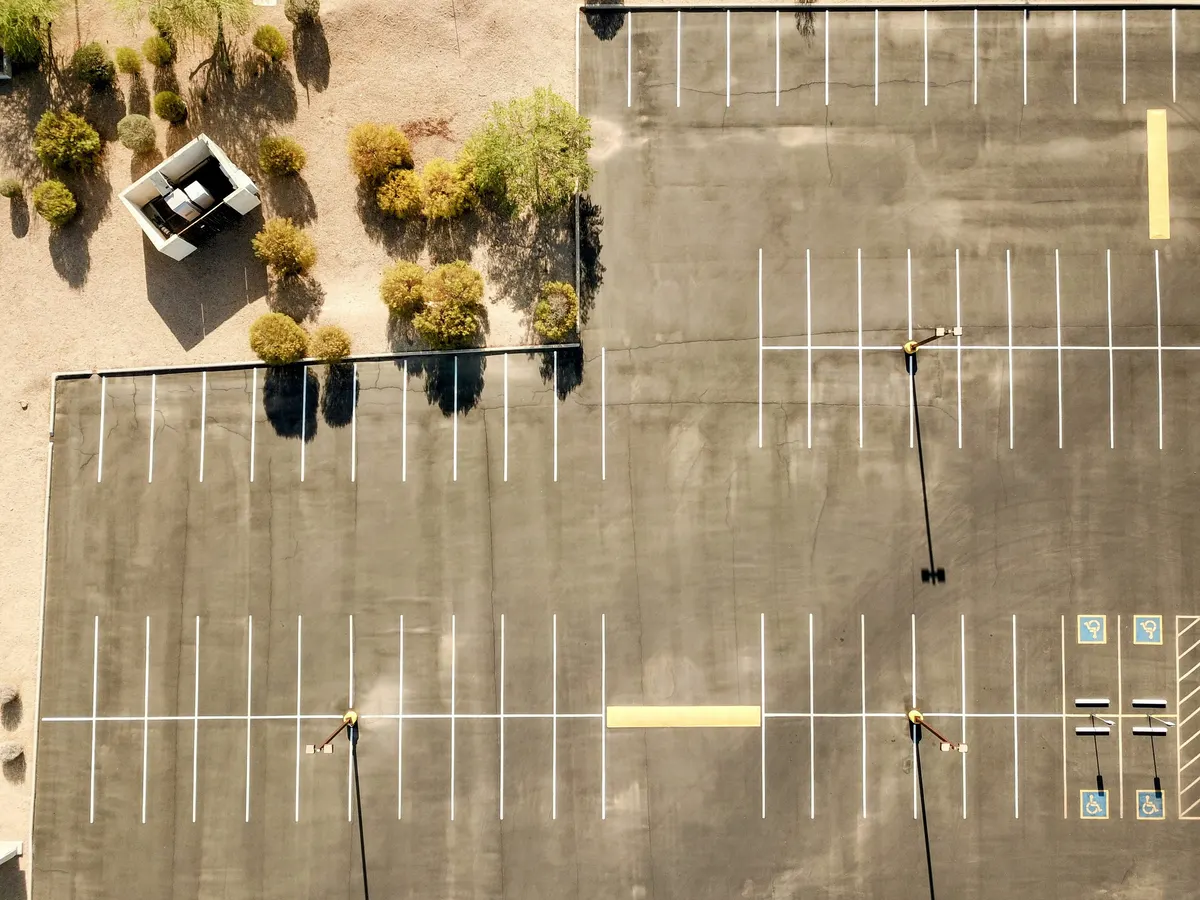 Line marking contractor creating painted lines on a commercial surface