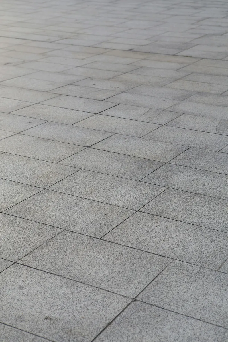 Asphalt contractor completing driveway paving work for an invoice