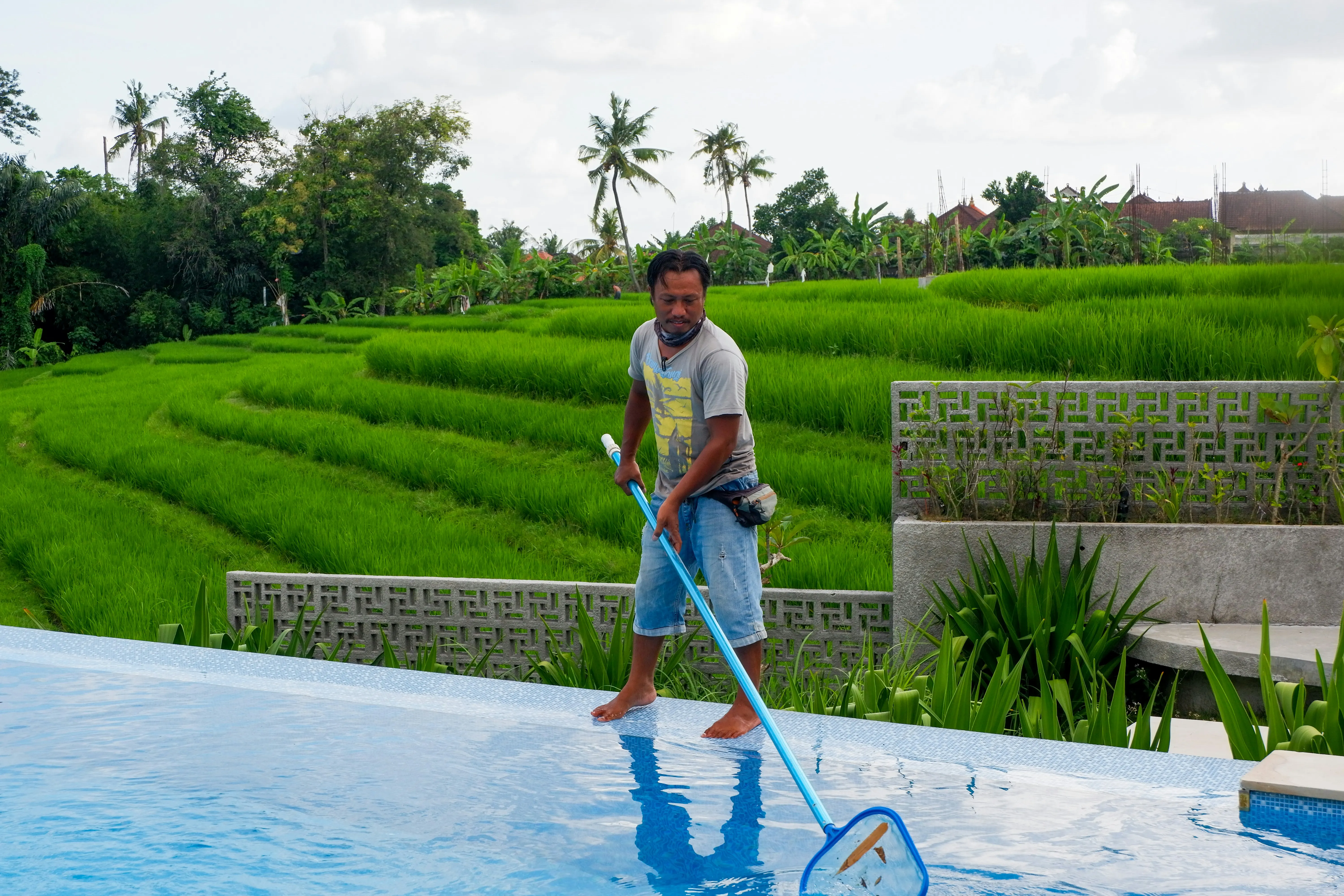 Pool maintenance technician preparing a pool service invoice