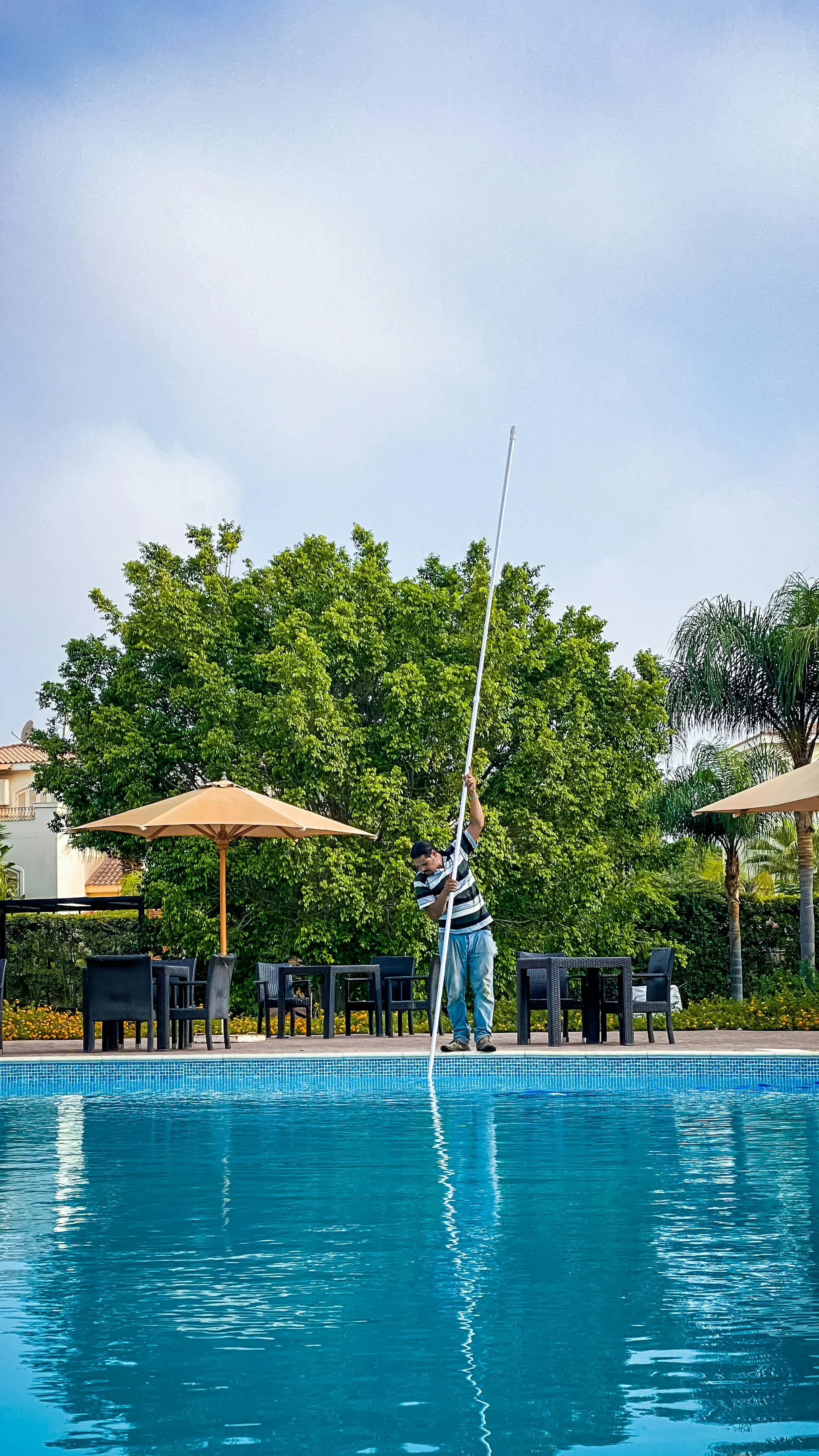 Swimming pool technician reviewing a pool service invoice example