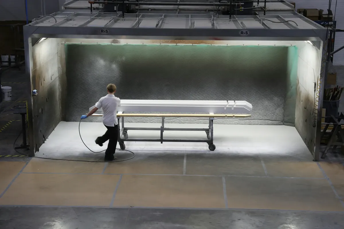 Powder coater applying a professional finish to metal components
