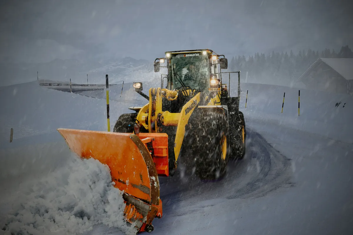 Snow removal contractor preparing a snow removal invoice template after clearing a driveway
