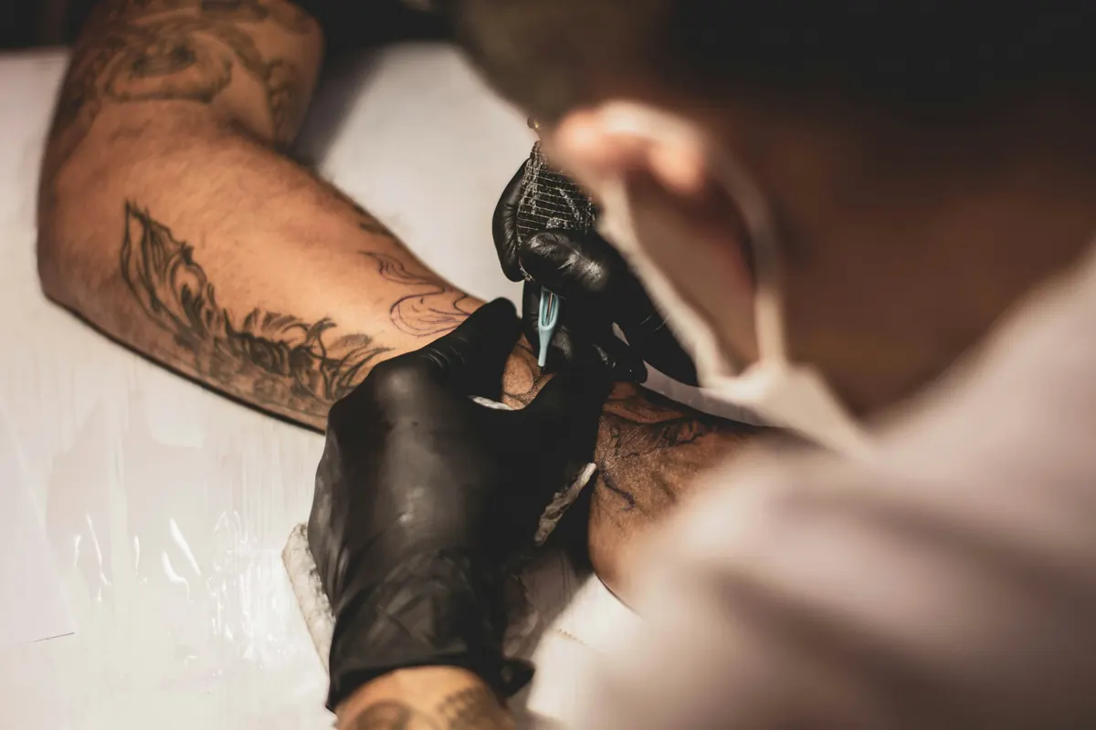 Tattoo artist preparing a professional tattoo invoice for a client