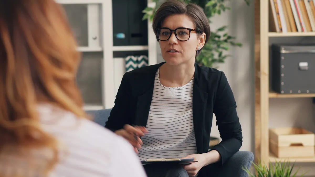 Therapist preparing a professional invoice for therapy and counselling services