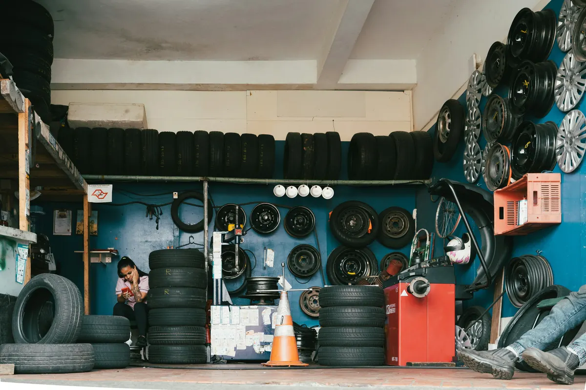 Tire technician preparing a tire shop invoice template for fitting and repair services