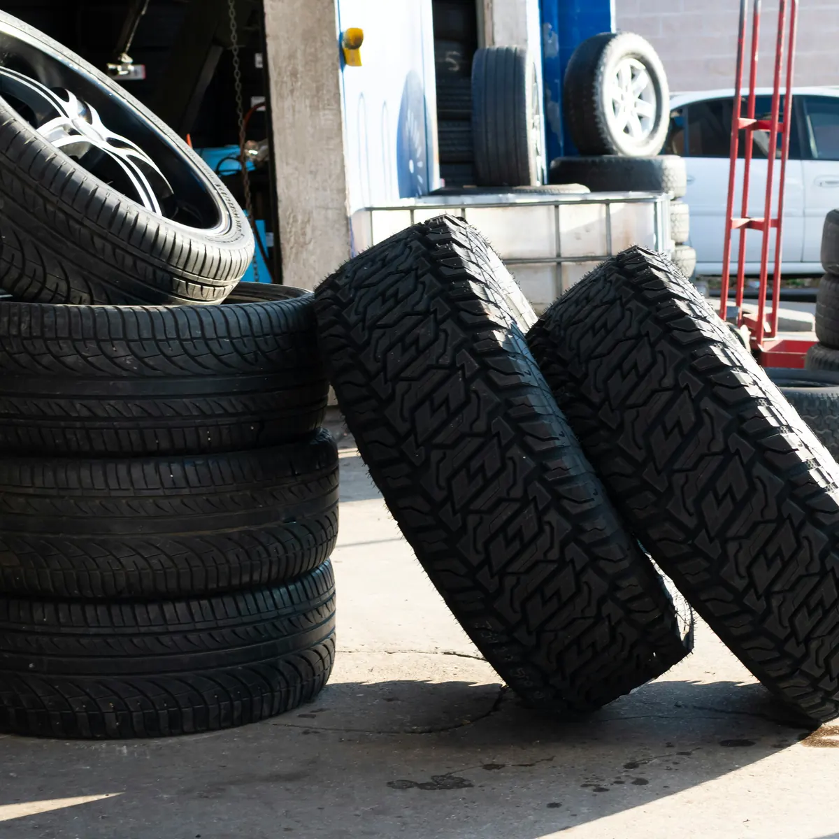 Tire shop employee creating an invoice for tire replacement and wheel services