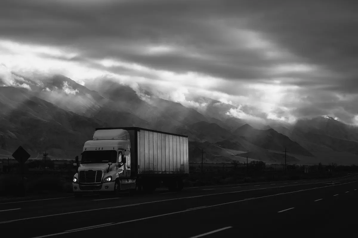 Owner operator truck driver reviewing an invoice for a completed load