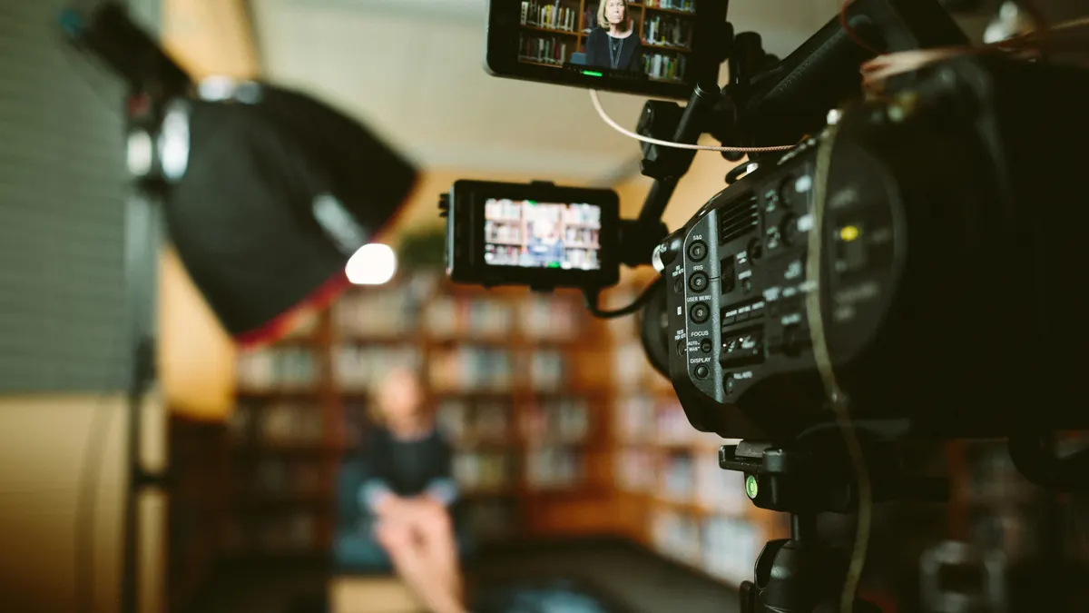 Videographer preparing a video production invoice template after filming